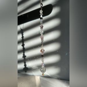 Car/window decor with pink and white crystals.